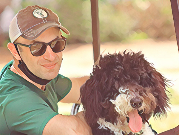 Camp Menominee Owner Jason Feldgreber cruising around camp with sidekick Buster